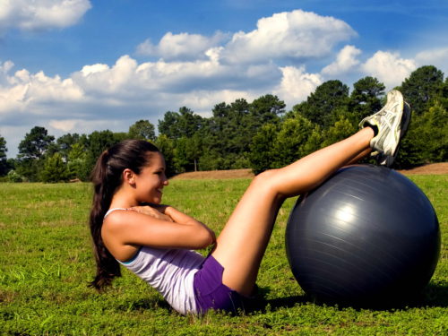 Yoga like poses with the aid of a large inflatable balance ball